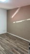 Leerer Raum mit Holzboden - Helle 2-Zimmer-Wohnung mit Terrasse und Garten in Ankum